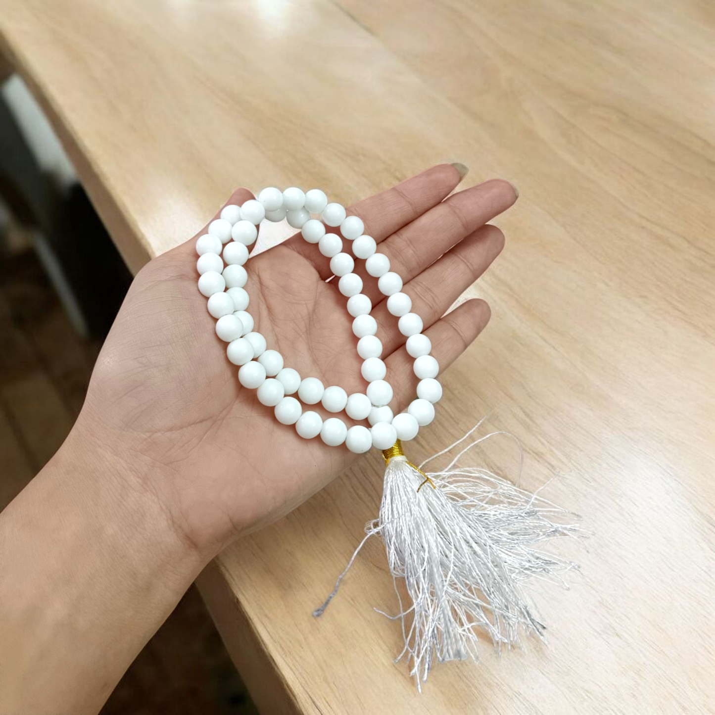 Image of White Agate Mala with 54+1 smooth 8mm Safed Hakik beads, neatly arranged for jaap, meditation, and emotional balance, on a soft spiritual background
