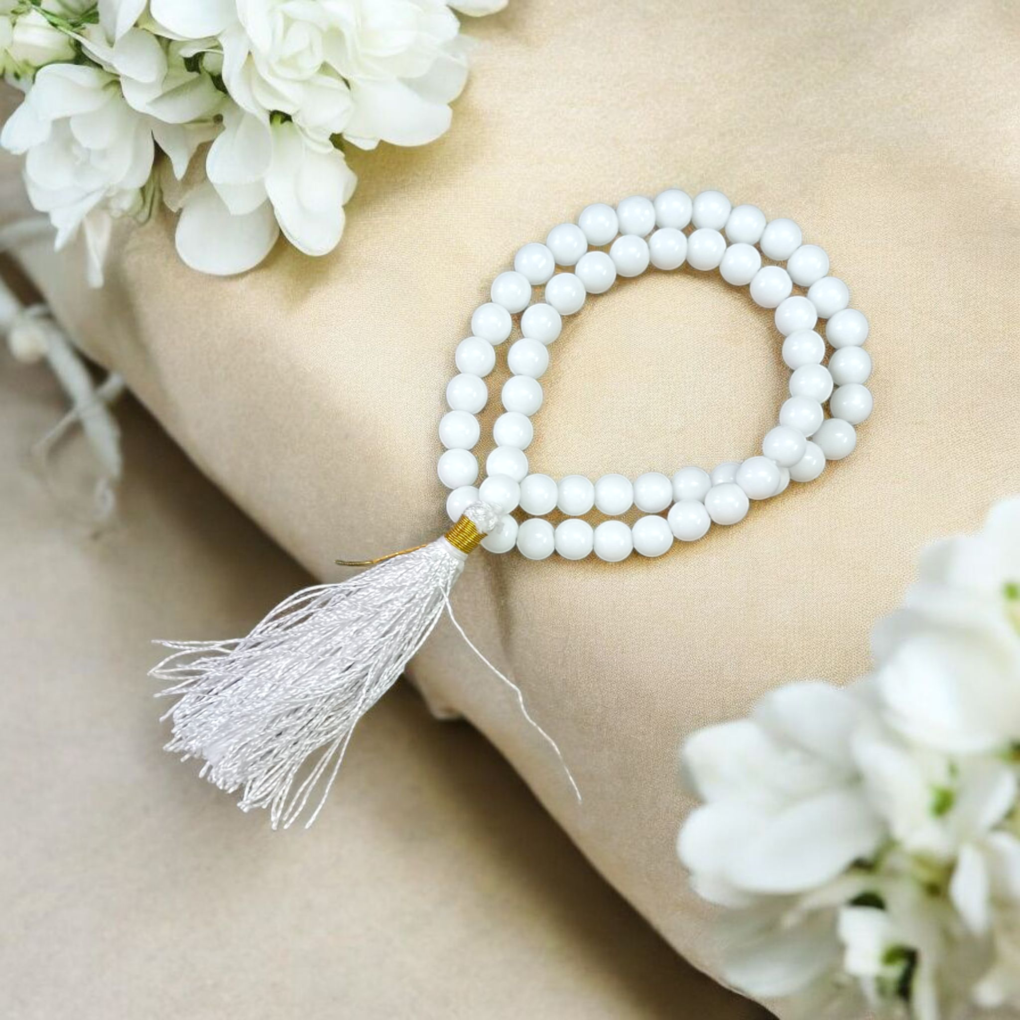 Image of White Agate Mala with 54+1 smooth 8mm Safed Hakik beads, neatly arranged for jaap, meditation, and emotional balance, on a soft spiritual background