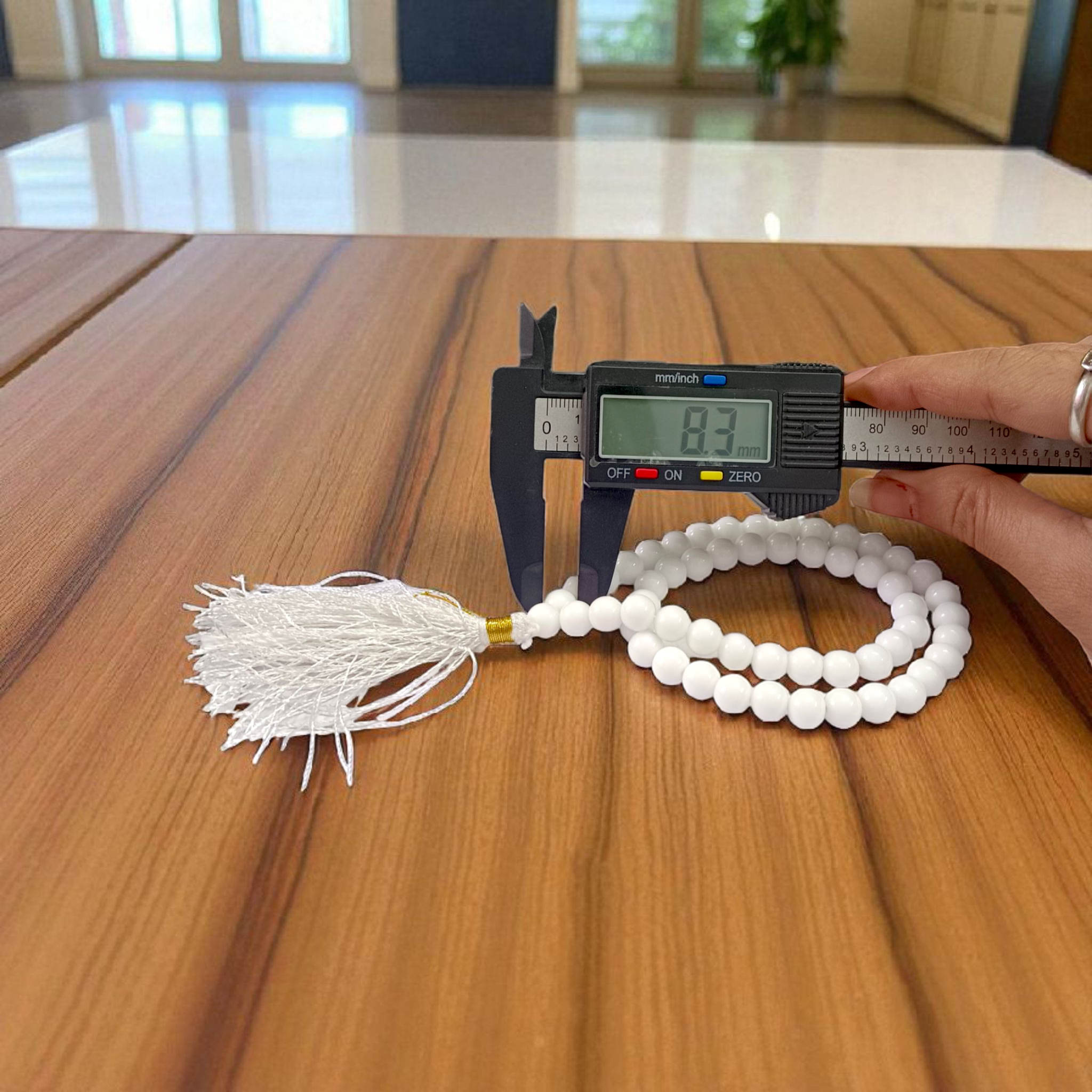 Image of White Agate Mala with 54+1 smooth 8mm Safed Hakik beads, neatly arranged for jaap, meditation, and emotional balance, on a soft spiritual background