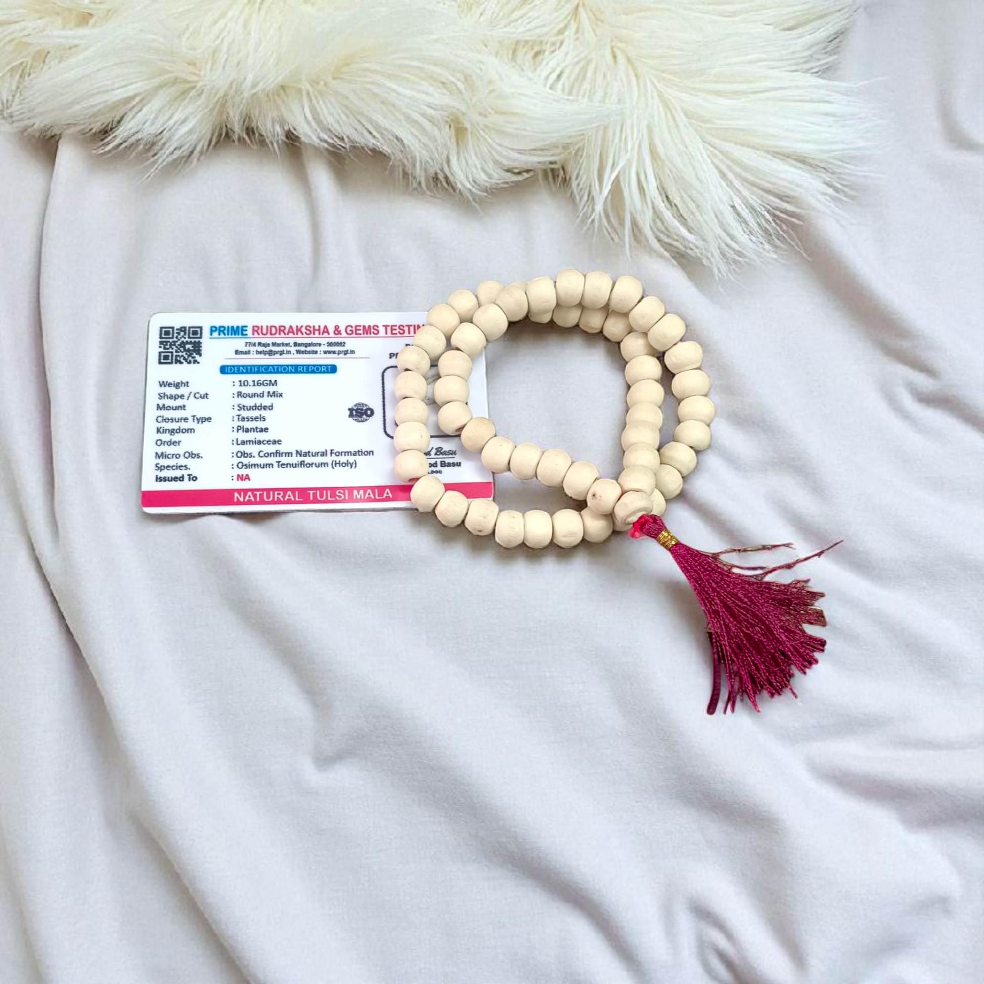 Image of a handcrafted Natural Tulsi Mala with 54+1 beads, 8mm size, laid neatly on a wooden surface with a spiritual setting background