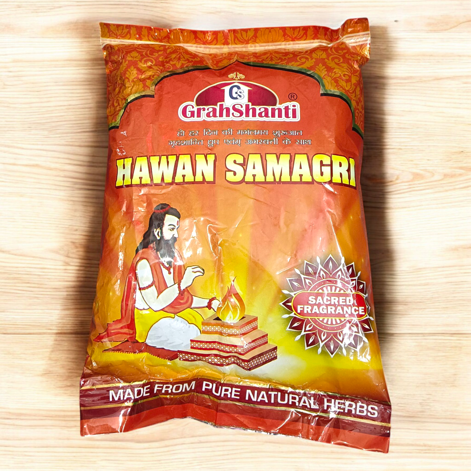 Image showing a 500GM pack of Hawan Samagri containing colorful natural herbs and powders used for Vedic rituals, placed beside puja essentials