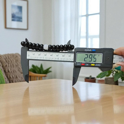 Image showing a stretchable bracelet made of 8mm natural black and white agate beads, arranged in alternating pattern, displayed on a neutral background