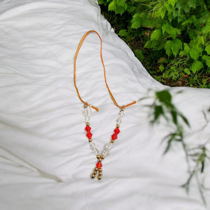 Laddu Gopal Mala with zircon beads in red, white, and golden colors, featuring an adjustable design, by Timeshopee