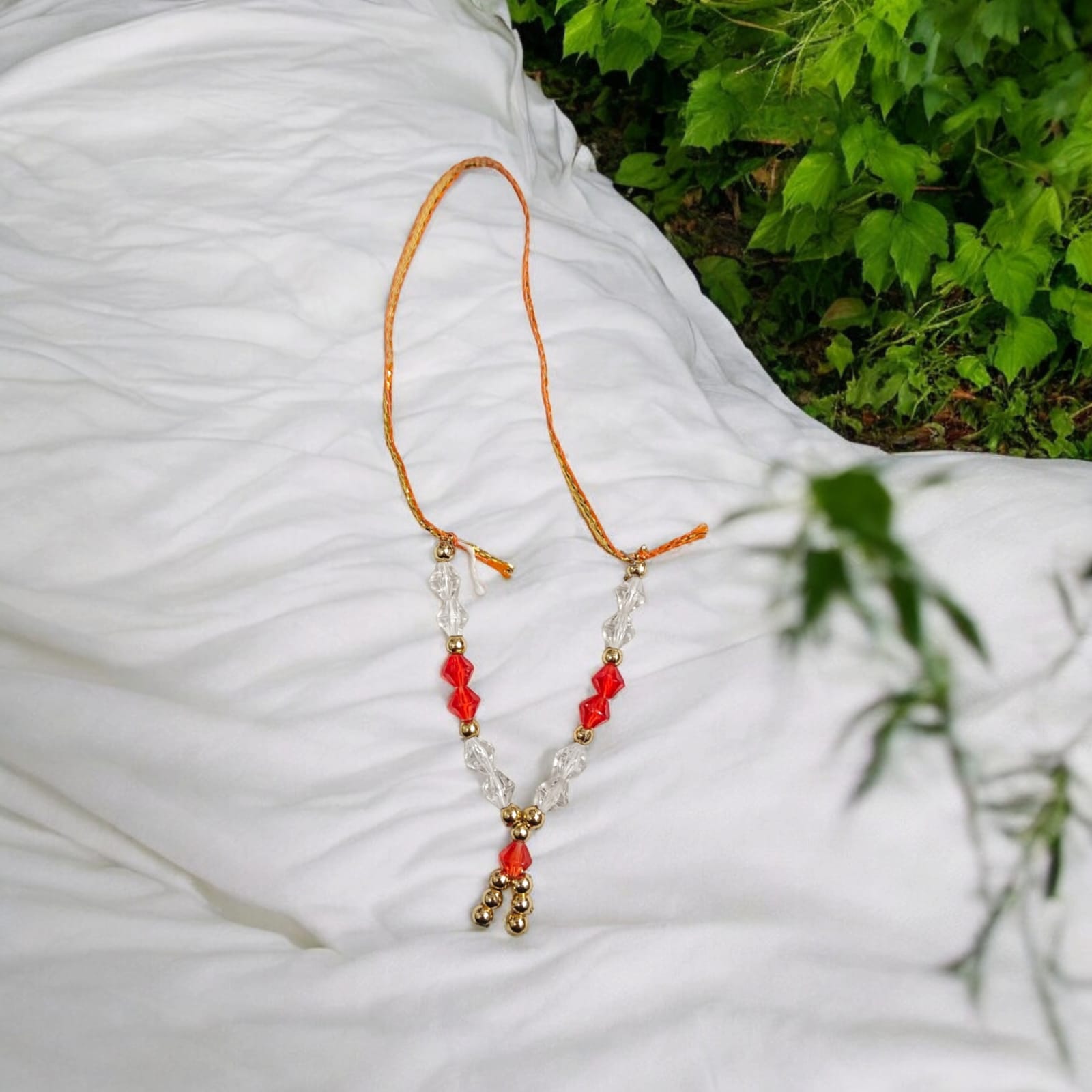 Laddu Gopal Mala with zircon beads in red, white, and golden colors, featuring an adjustable design, by Timeshopee