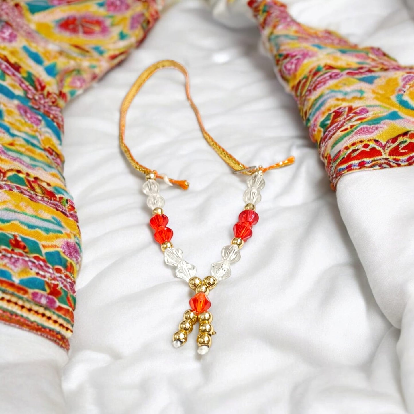 Laddu Gopal Mala with zircon beads in red, white, and golden colors, featuring an adjustable design, by Timeshopee