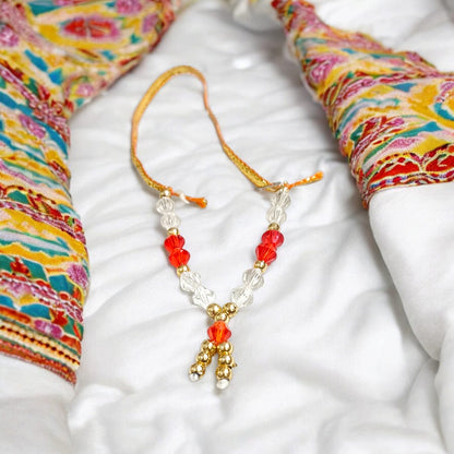 Laddu Gopal Mala with zircon beads in red, white, and golden colors, featuring an adjustable design, by Timeshopee