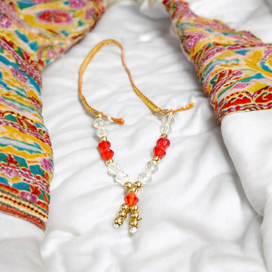 Laddu Gopal Mala with zircon beads in red, white, and golden colors, featuring an adjustable design, by Timeshopee