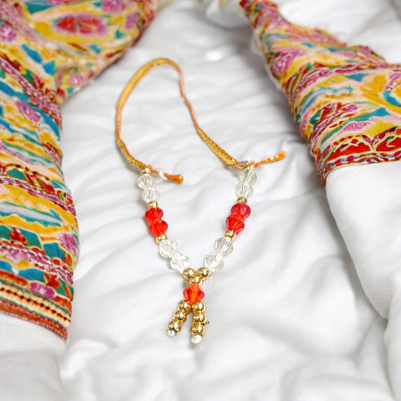 Laddu Gopal Mala with zircon beads in red, white, and golden colors, featuring an adjustable design, by Timeshopee