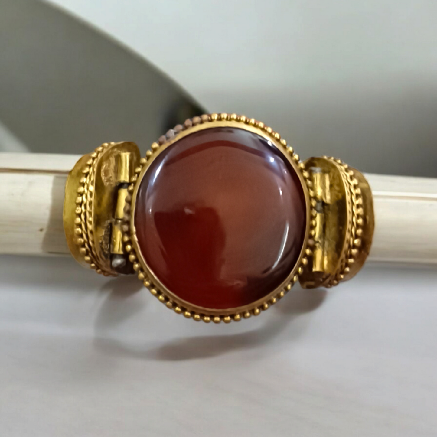Lal Hakik Bracelet featuring red agate stone set in antique brass cuff, accompanied by lab certificate.