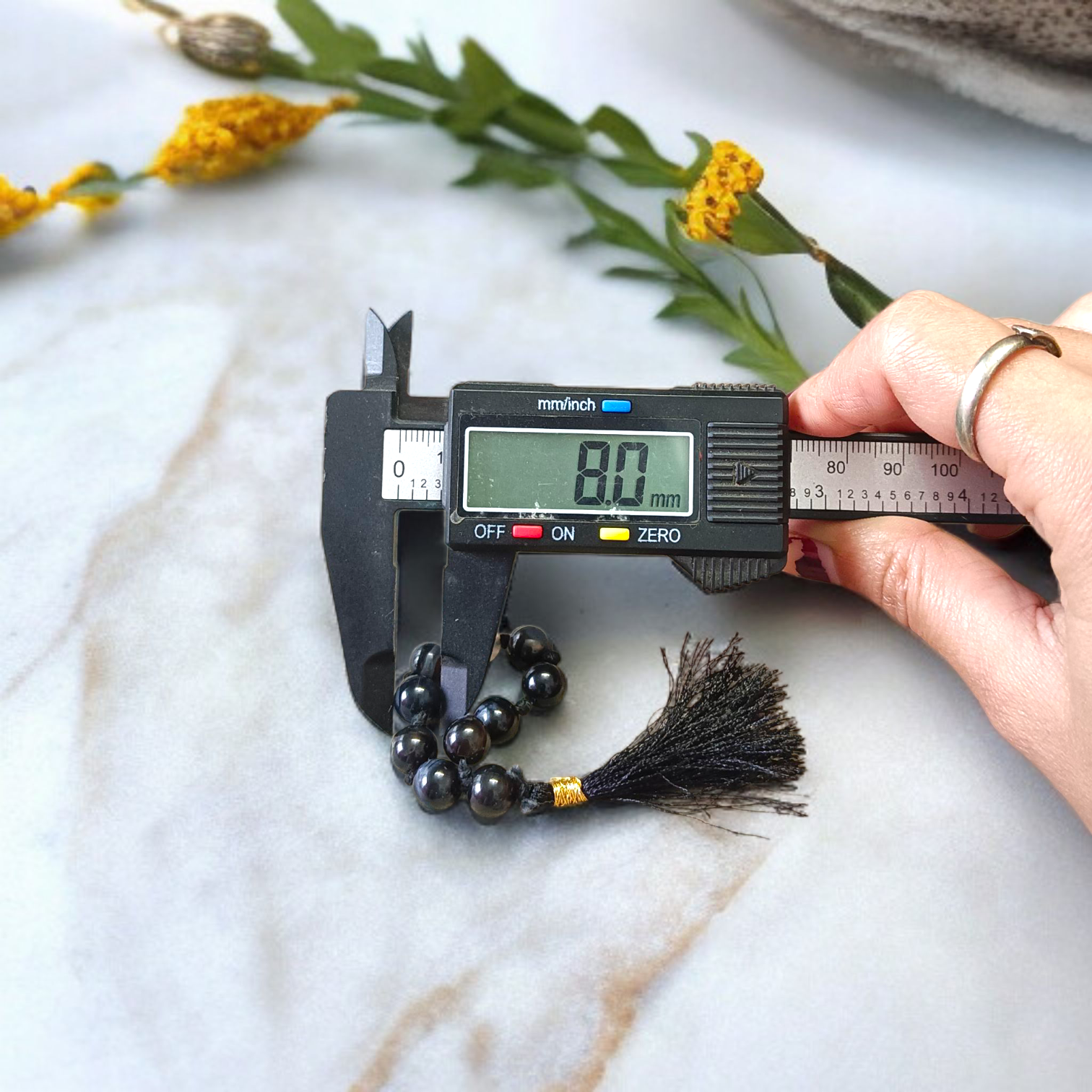 Natural Black Sulemani Finger Mala with 9+1 round 8mm beads displayed on a soft background, ideal for meditation, mantra chanting, and prayer