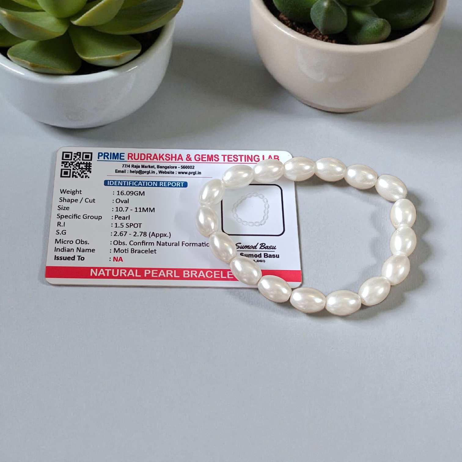 Natural Pearl Bracelet (Moti Mala) with 10–11mm round white beads, displayed on a velvet background, symbolizing peace and emotional balance