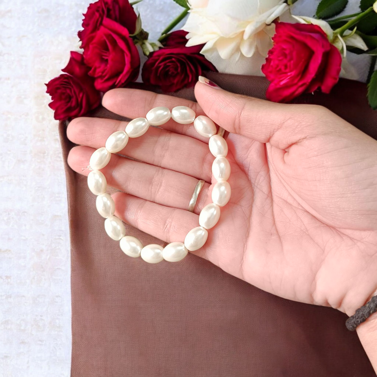 Natural Pearl Bracelet (Moti Mala) with 10–11mm round white beads, displayed on a velvet background, symbolizing peace and emotional balance