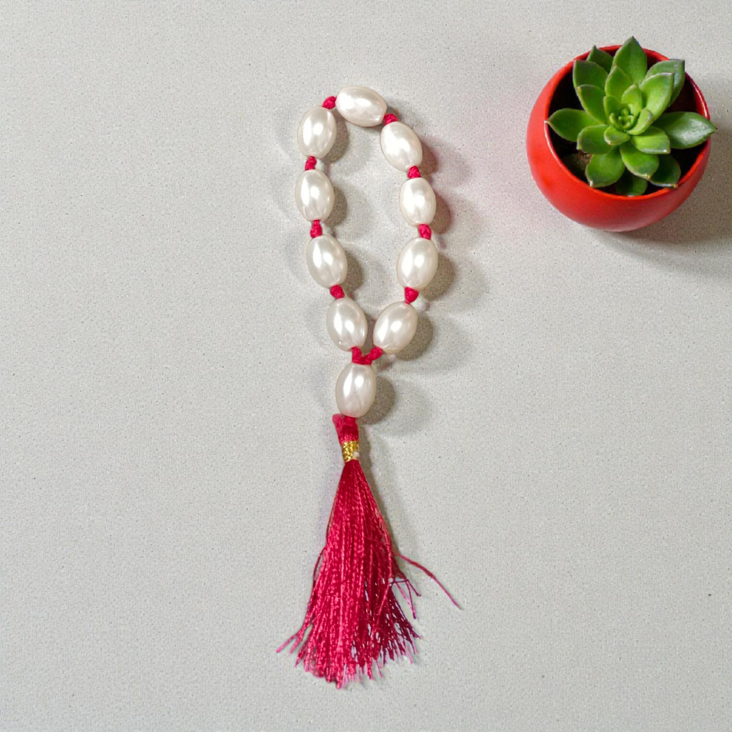 Natural Pearl Finger Mala with 9+1 round white pearls (10–11mm) displayed on a soft background, ideal for chanting and meditation
