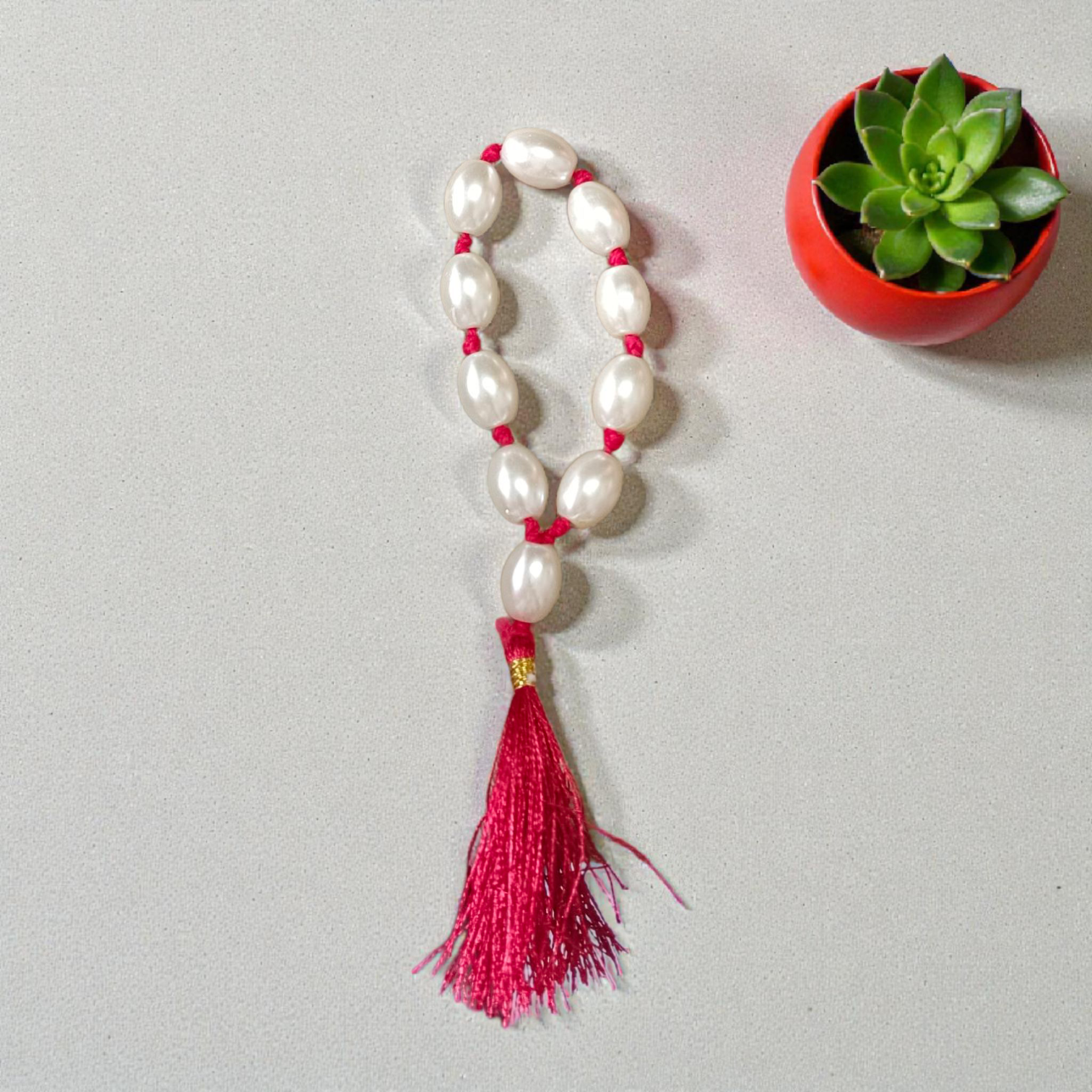 Natural Pearl Finger Mala with 9+1 round white pearls (10–11mm) displayed on a soft background, ideal for chanting and meditation