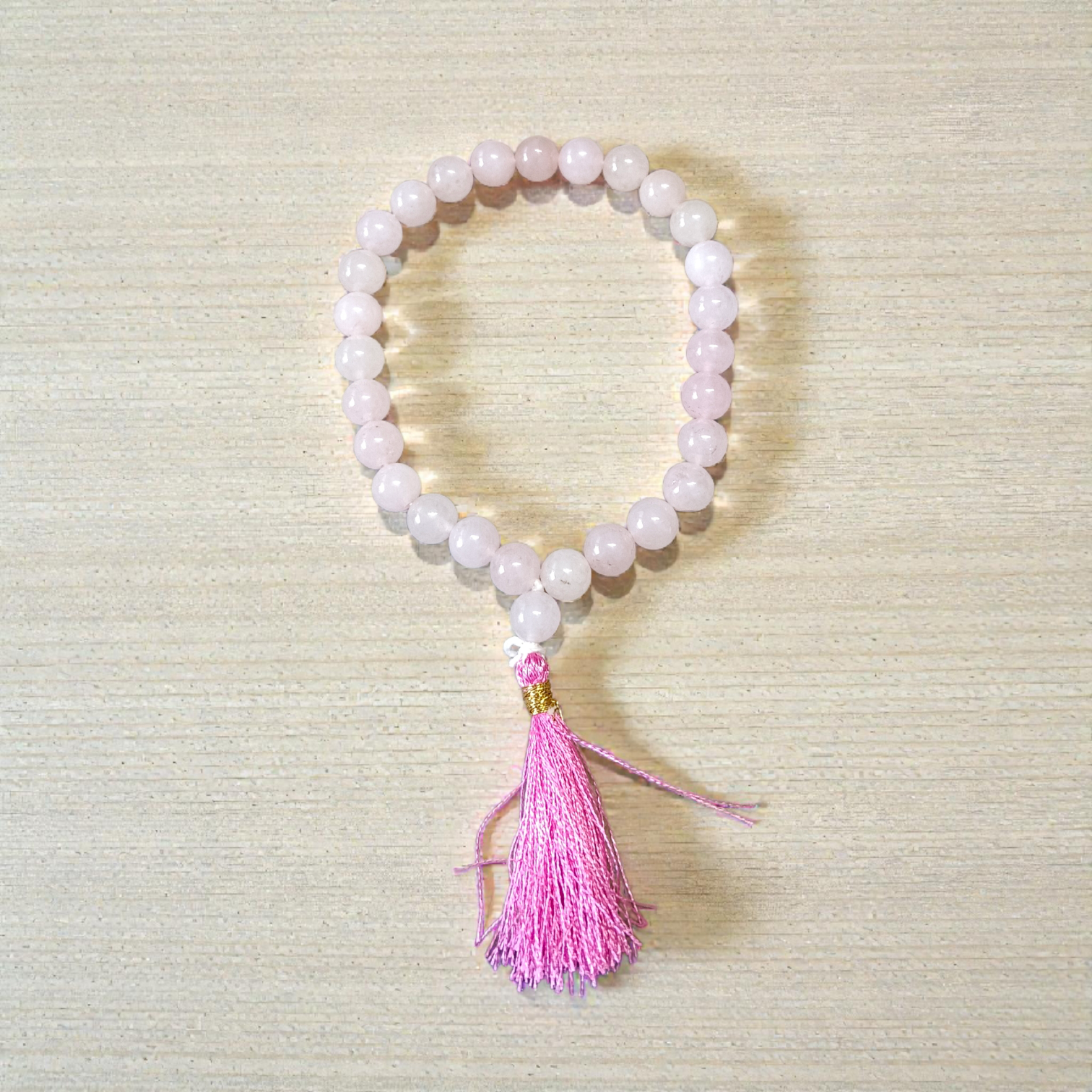 Natural Rose Quartz Mala with 8mm pink beads arranged neatly for meditation and spiritual use