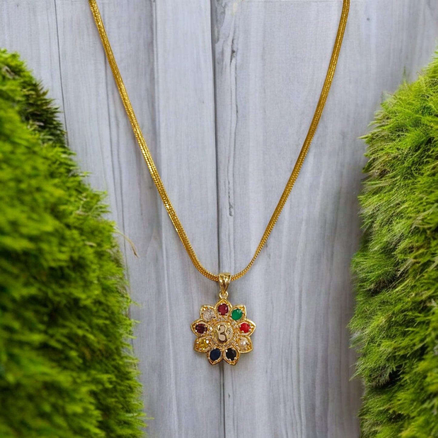 Navratan Locket with Om symbol and nine gemstones, including a free gold-plated chain for spiritual and astrological benefits.