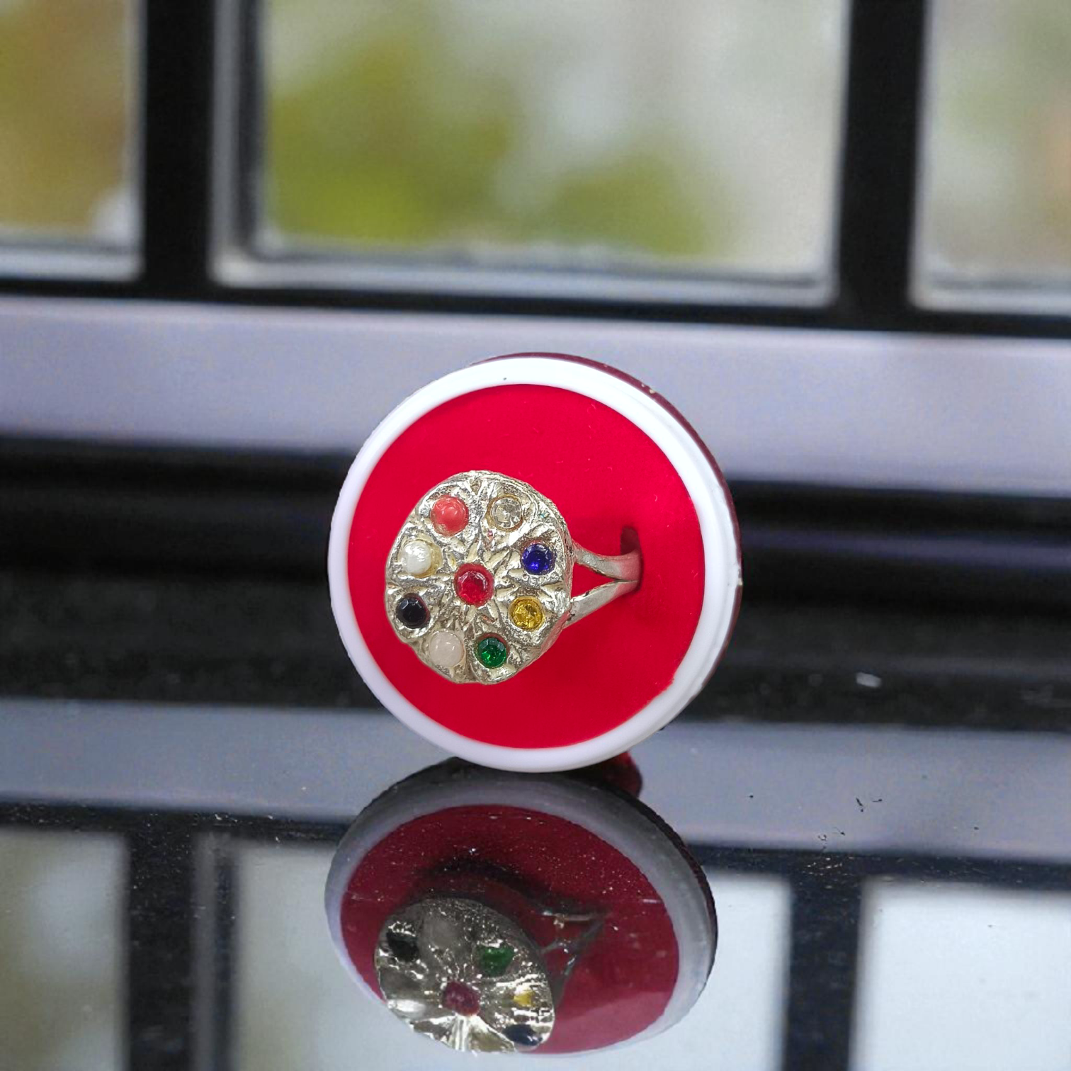 Oval-shaped Navratan Ring with silver plating, featuring nine gemstones for astrological balance and spiritual 