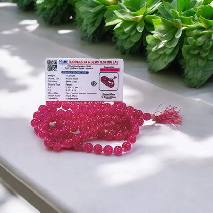Pink Agate Mala with 8MM beads and 108+1 bead count, lab-certified for authenticity, displayed in a close-up view showing its delicate pink hues.