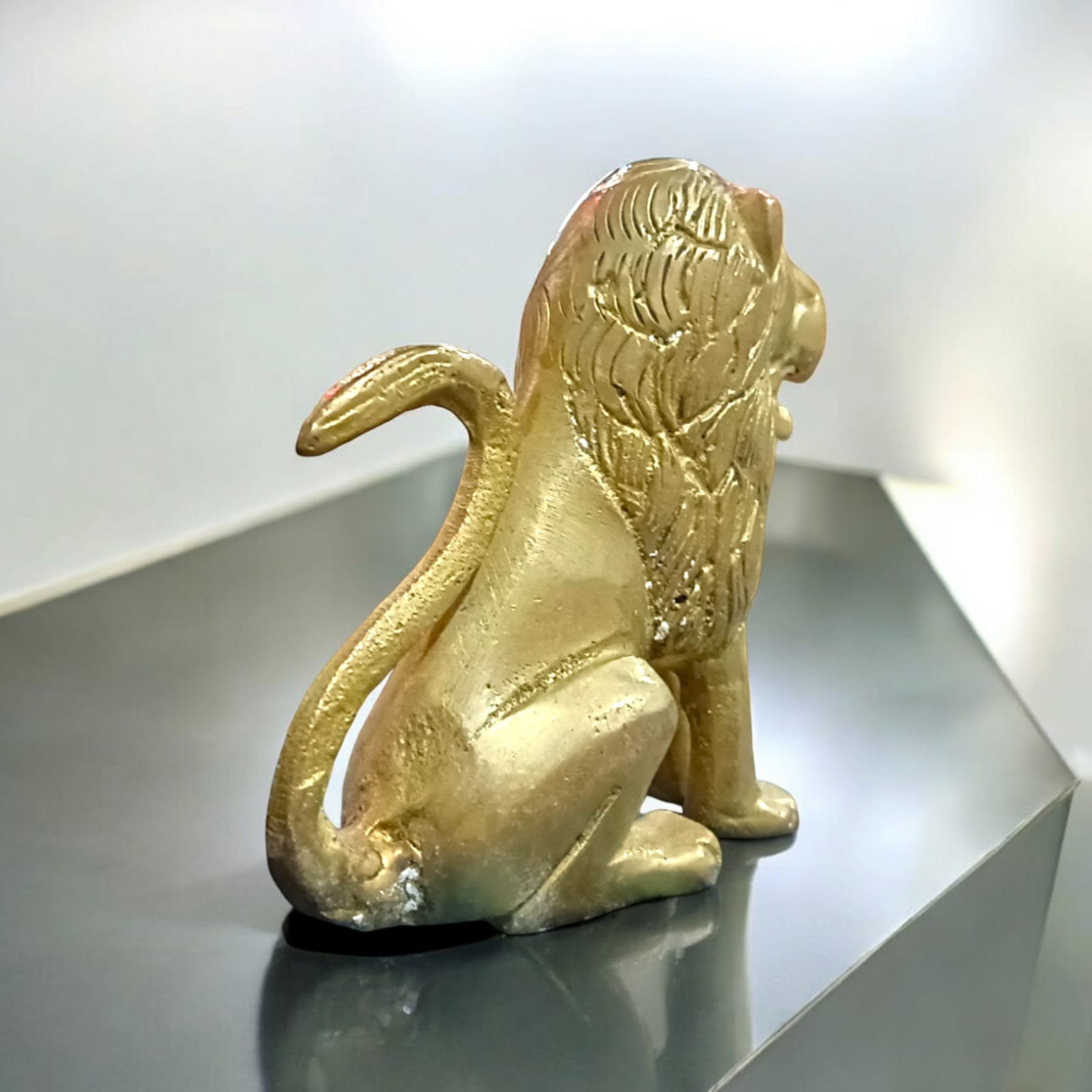 Pure Brass Lion Idol with intricate craftsmanship, perfect for table or temple decoration.