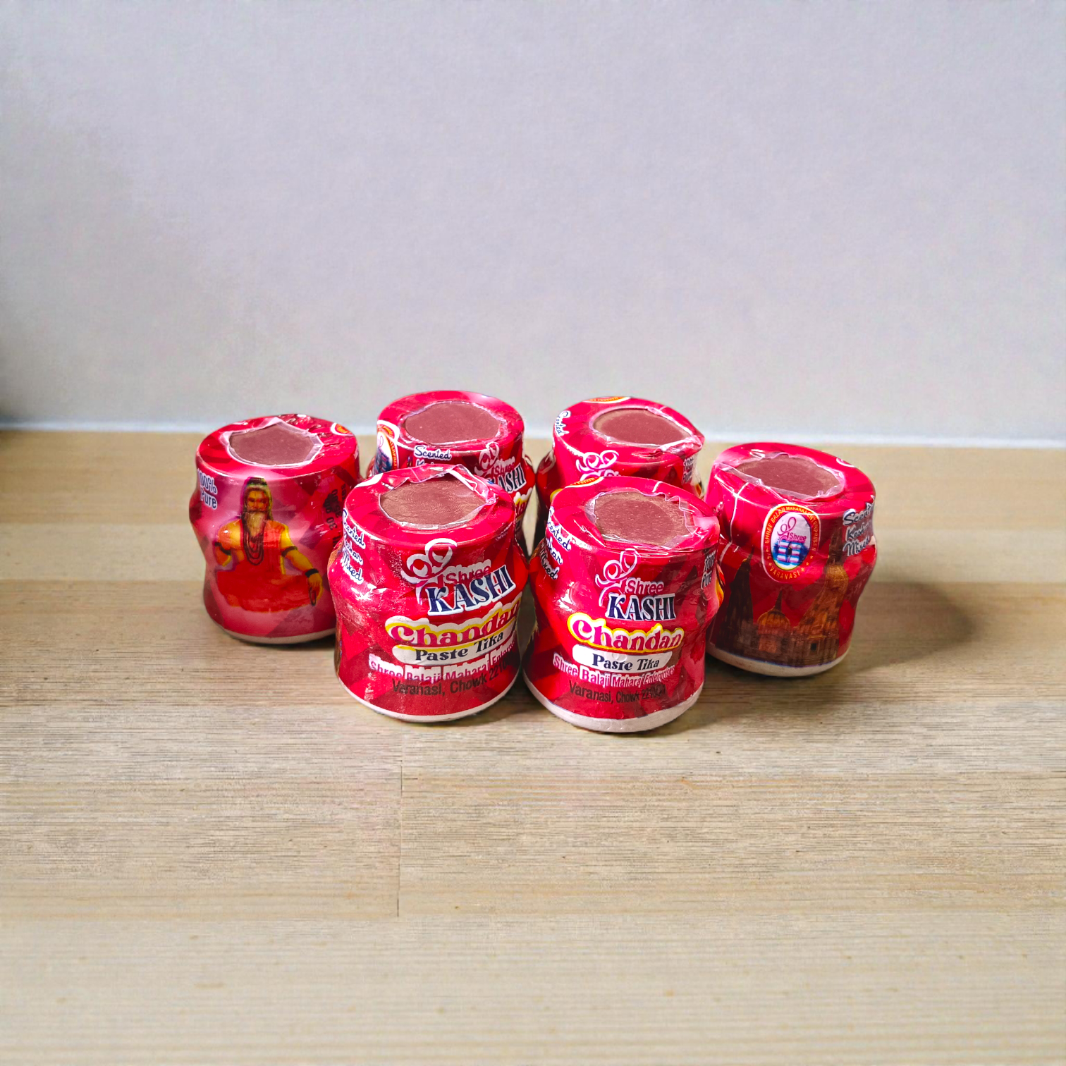 Red chandan paste container used for tilak, puja, and religious rituals