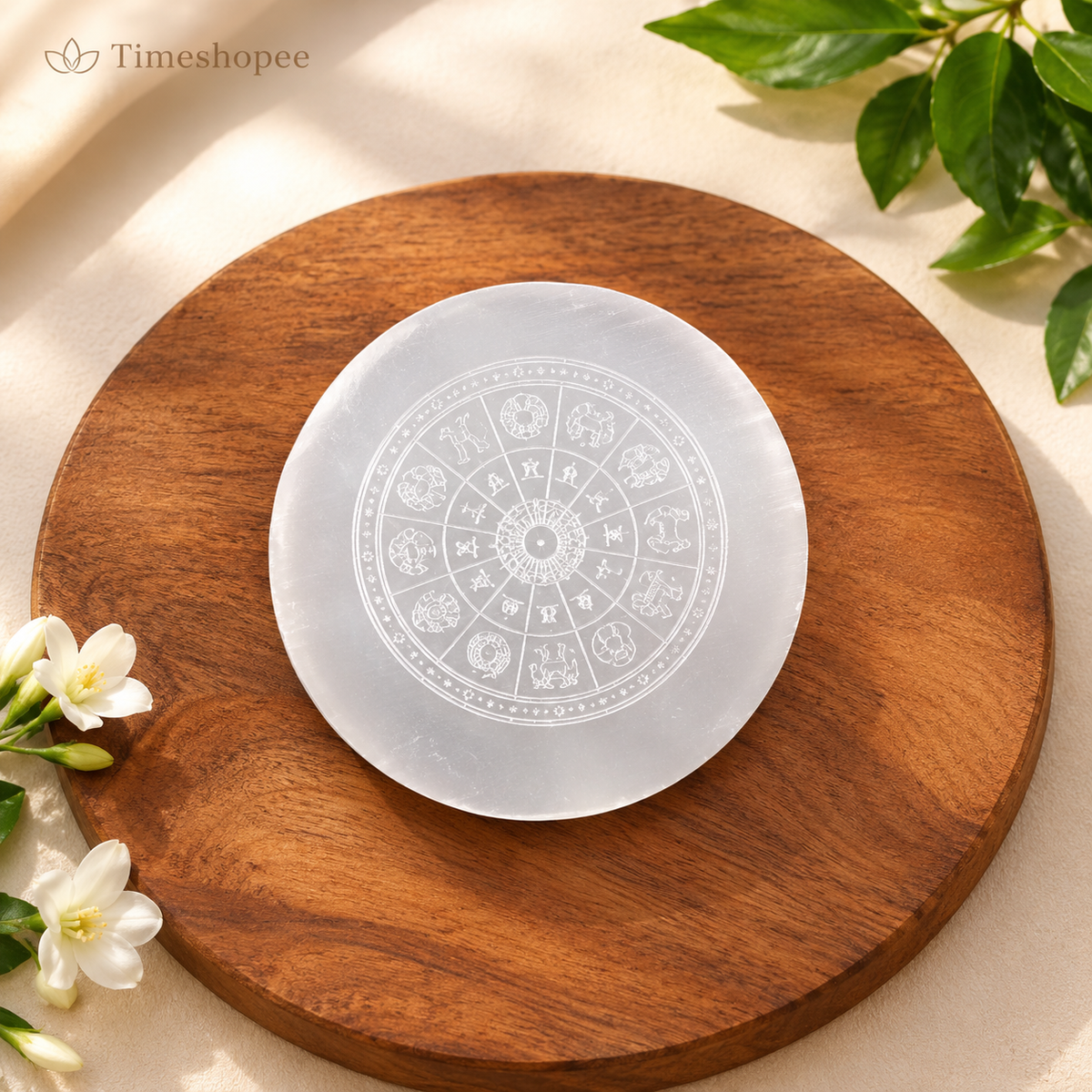 A polished round Selenite charging plate featuring a carved Om symbol, used for pooja, décor, and energy cleansing