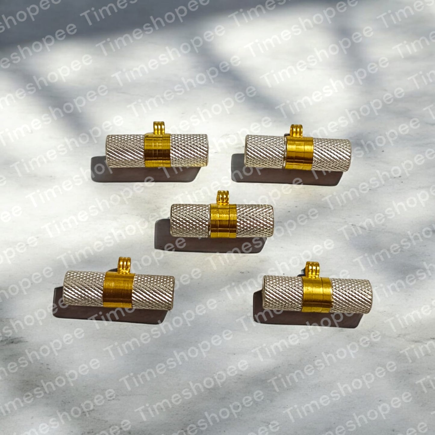 Silver and golden taweezes with Bhojpatra sheet, displayed on a neutral background