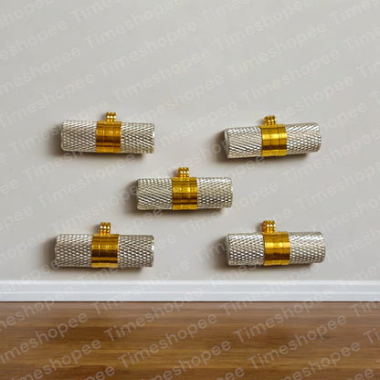 Silver and golden taweezes with Bhojpatra sheet, displayed on a neutral background