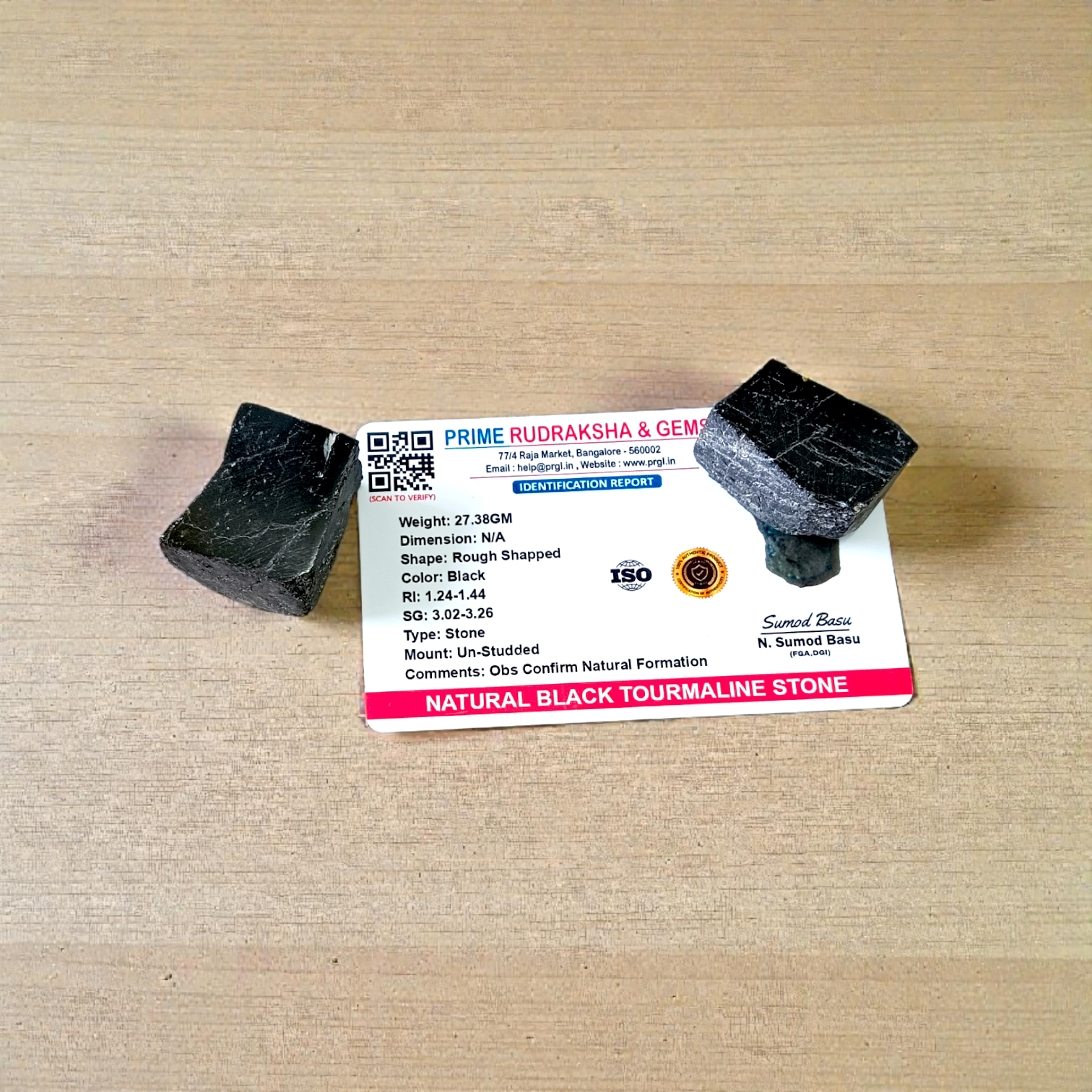 Two polished black Tourmaline stones with smooth texture, placed side by side, symbolizing protection, grounding, and Root Chakra energy