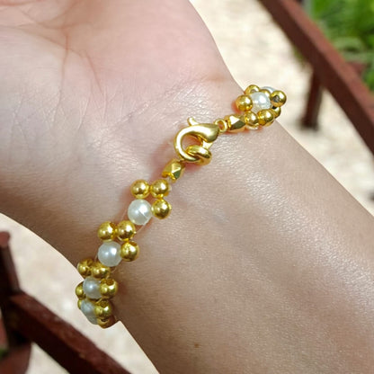 White and golden pearl bead bracelet with a lobster clasp, designed for girls and women, perfect for matching with golden and white outfits.