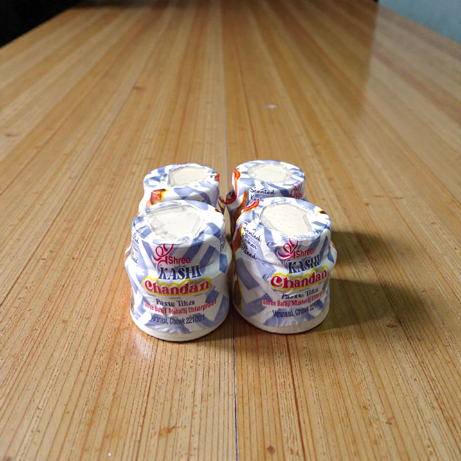 White chandan paste container used for tilak, puja, and religious rituals